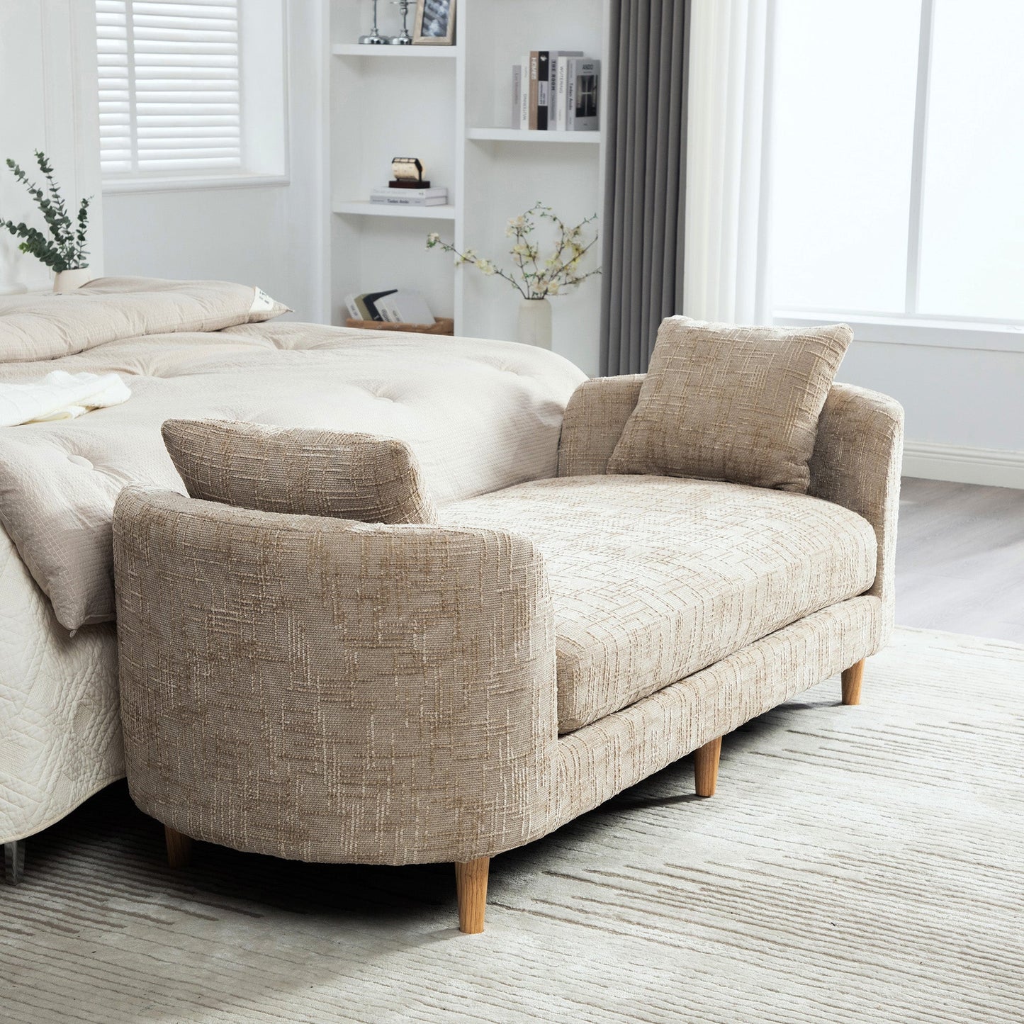 End-of-bed bench with armrests in beige textured upholstery and light wooden legs on Tampa Home & Garden Store