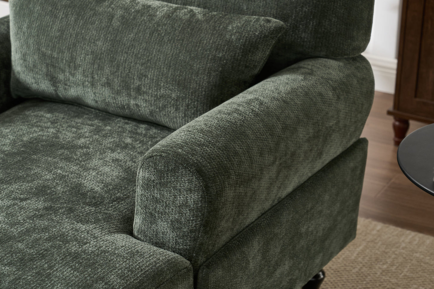Modern green chaise lounge recliner with plush cushions and curved arm beside a side table on Tampa Home & Garden Store