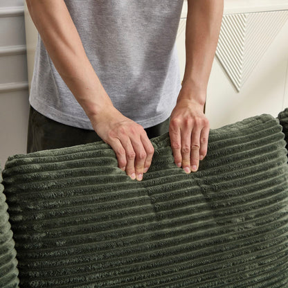 Green ribbed plush throw blanket being folded by hands on Tampa Home & Garden Store