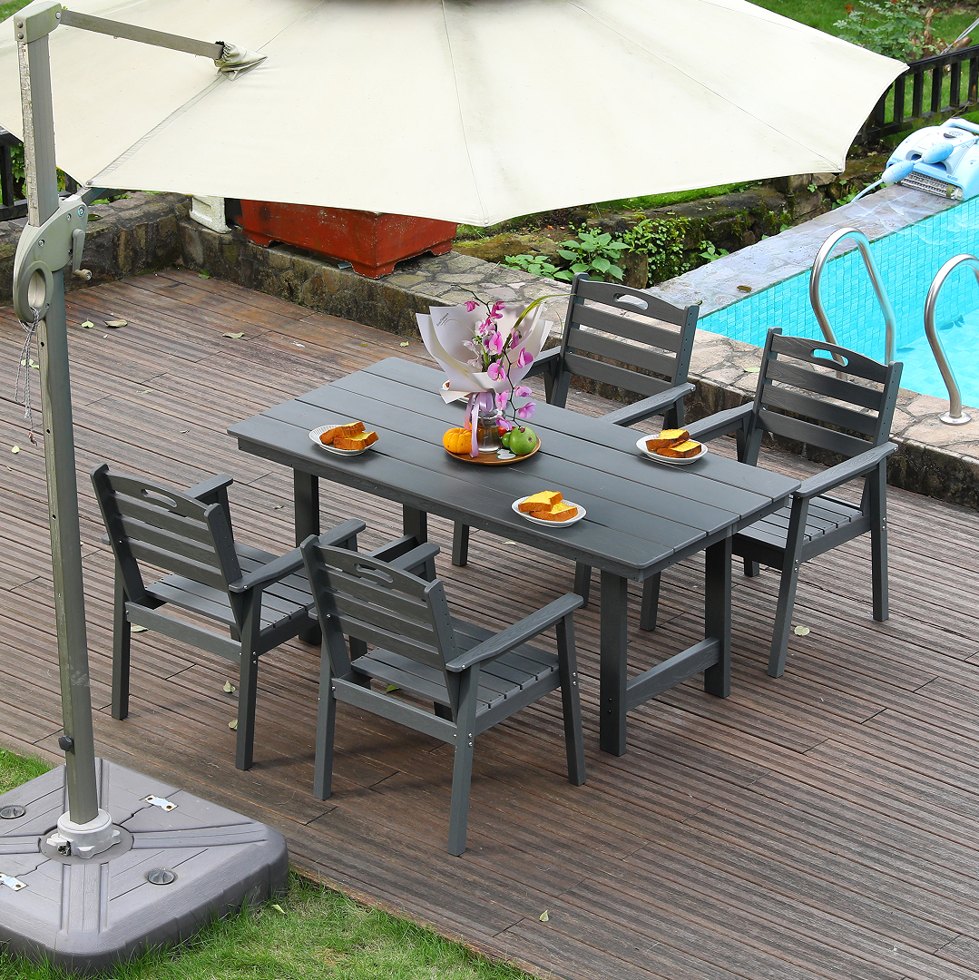HDPE outdoor dining set with table and four dark gray chairs on a deck under an umbrella on Tampa Home & Garden Store