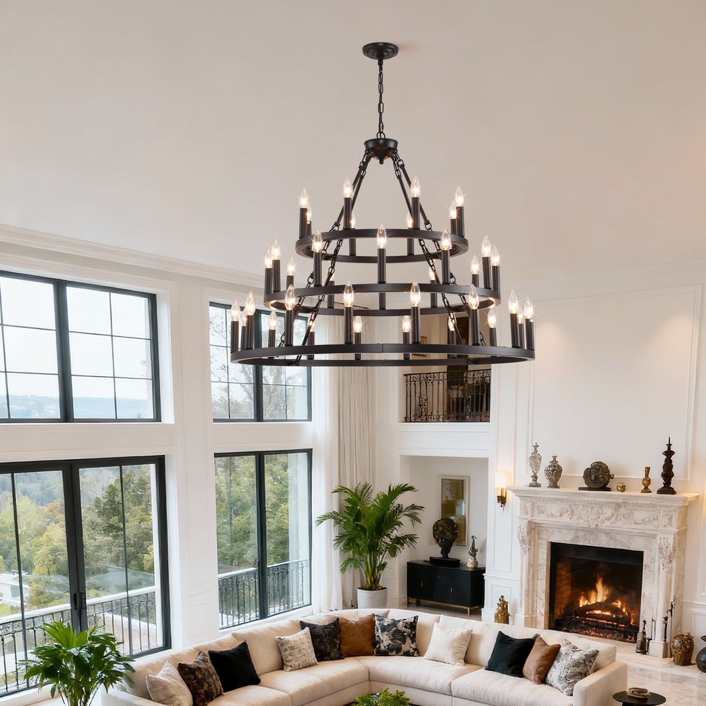 3-tier wagon wheel chandelier, black metal with candle bulbs, ceiling hung over living room on Tampa Home & Garden Store