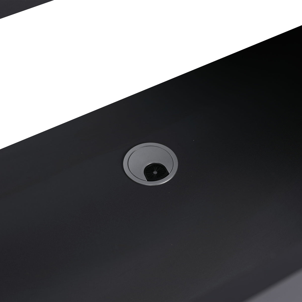 Freestanding bath vanity top in black with a large circular metal drain on surface on Tampa Home & Garden Store