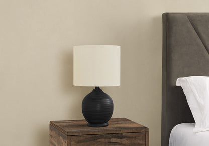 Table lamp ceramic black with cream lampshade on a wooden nightstand in a bedroom on Tampa Home & Garden Store