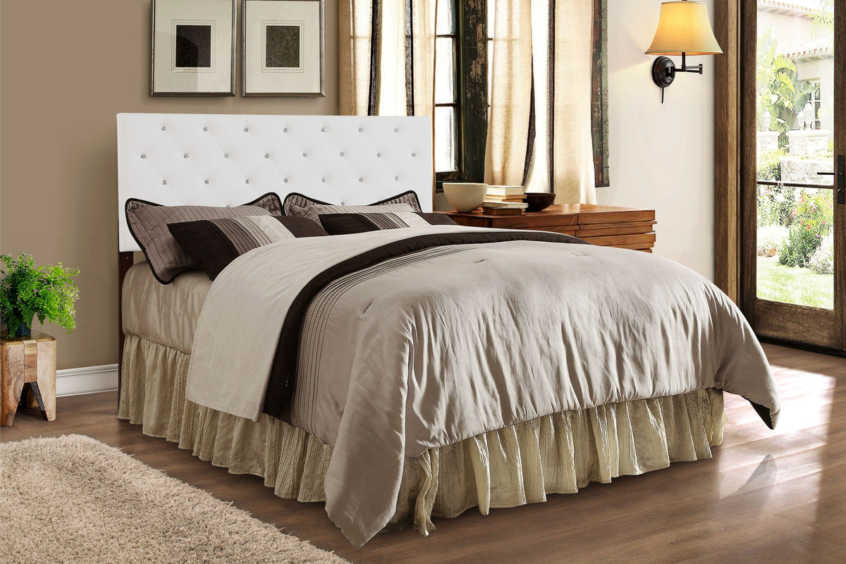 Upholstered headboard with button tufting in white fabric and crystal accents on Tampa Home & Garden Store