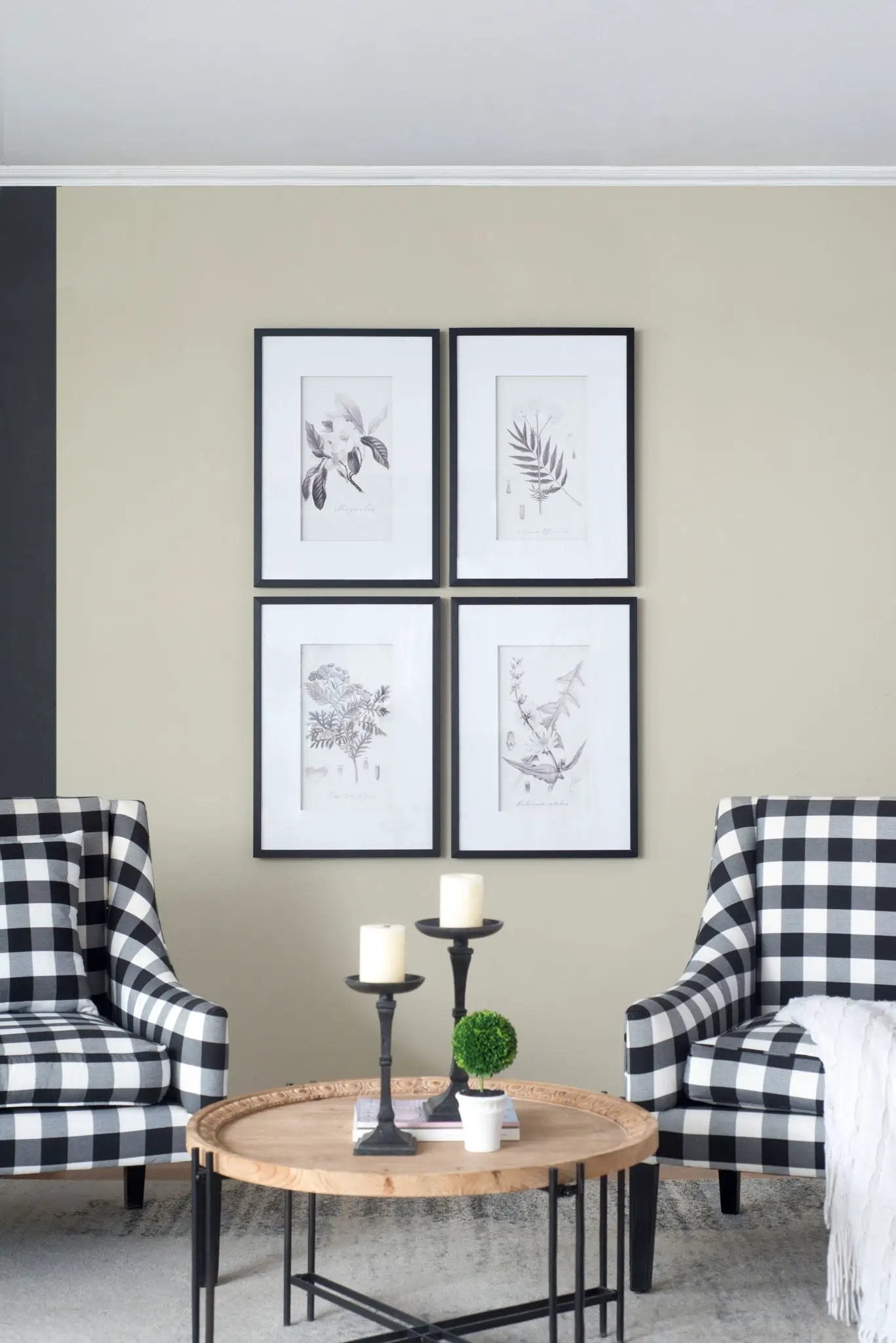 Framed botanical wall art prints set of 4 in black frames with white mats on beige wall on Tampa Home & Garden Store
