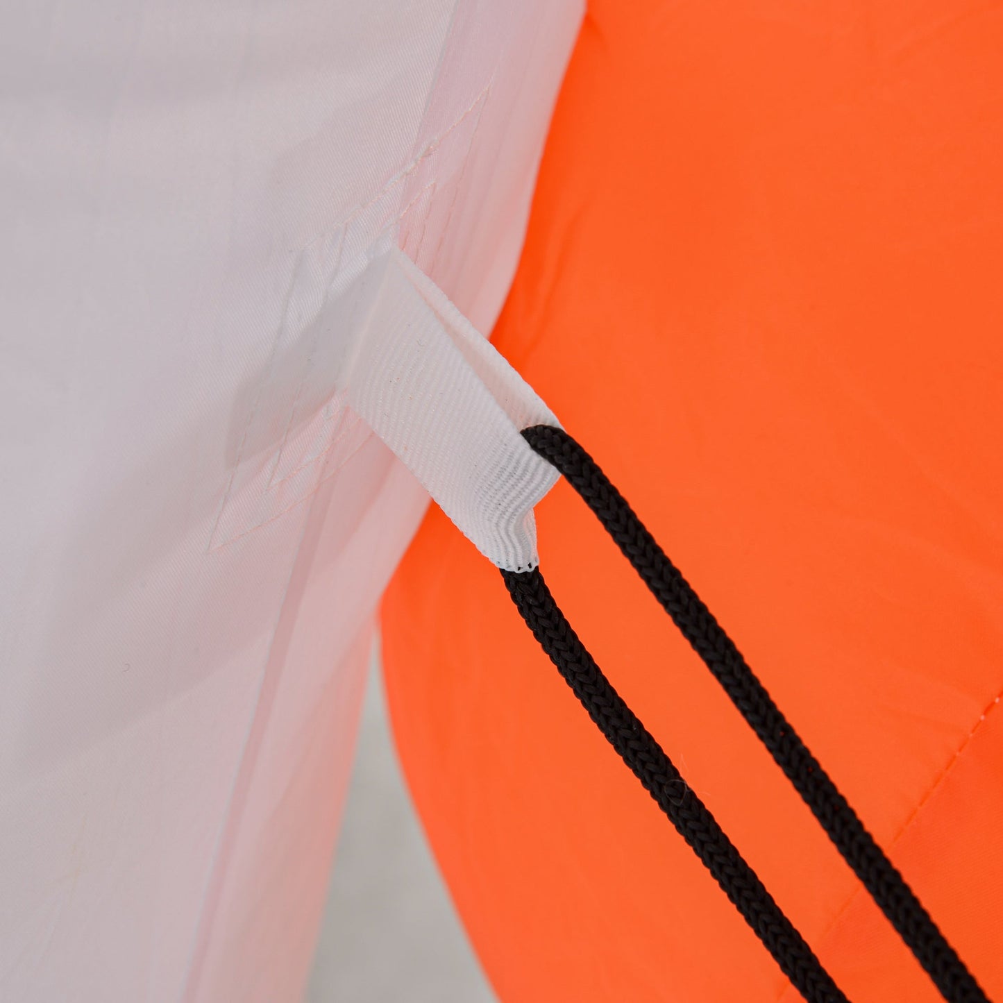 HouseOfZazla inflatable ghost close-up: white fabric, black cords on orange backdrop on Tampa Home & Garden Store