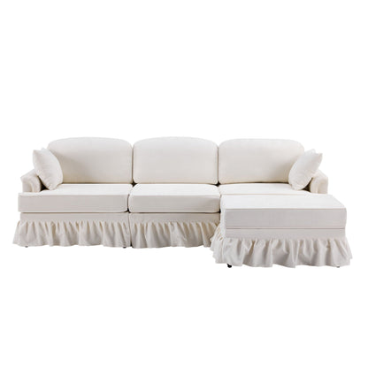 L-shaped white sectional sofa with removable ruffled skirt, flared arms, and ottoman on Tampa Home & Garden Store