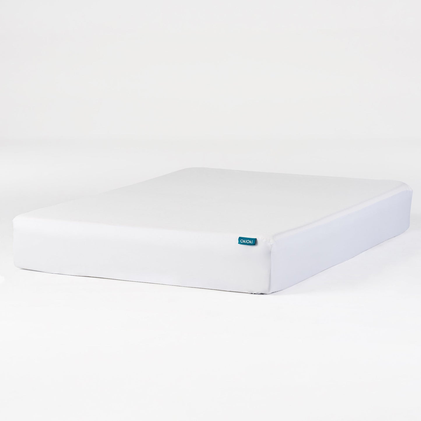 OkiOki Mattress Protector Queen white cover with teal logo tag on edge on Tampa Home & Garden Store