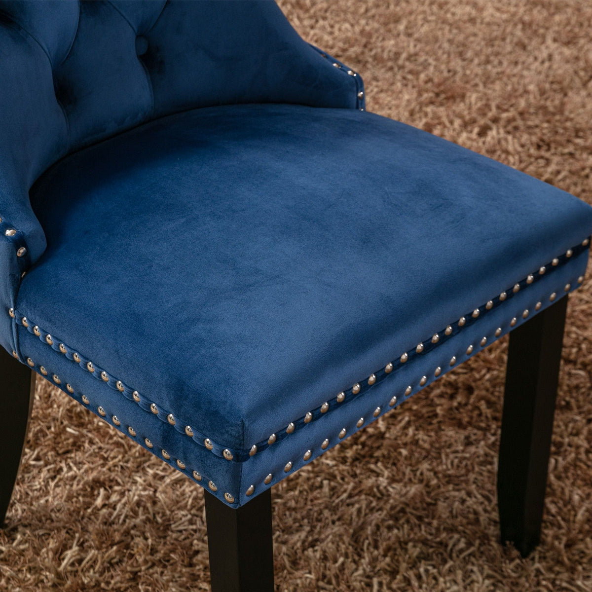 Tufted dining chair set in blue velvet with nailhead trim and black legs on Tampa Home & Garden Store