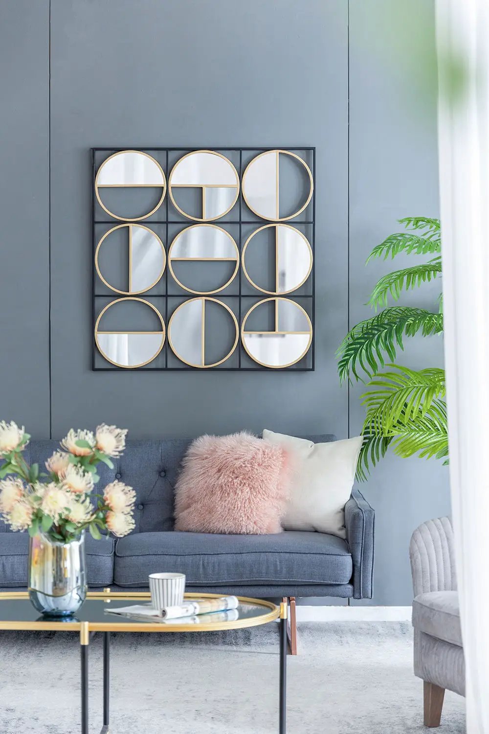 Eclectic metal beaded wall mirror with nine round mirrors in gold-trimmed circles on a black grid on Tampa Home & Garden Store