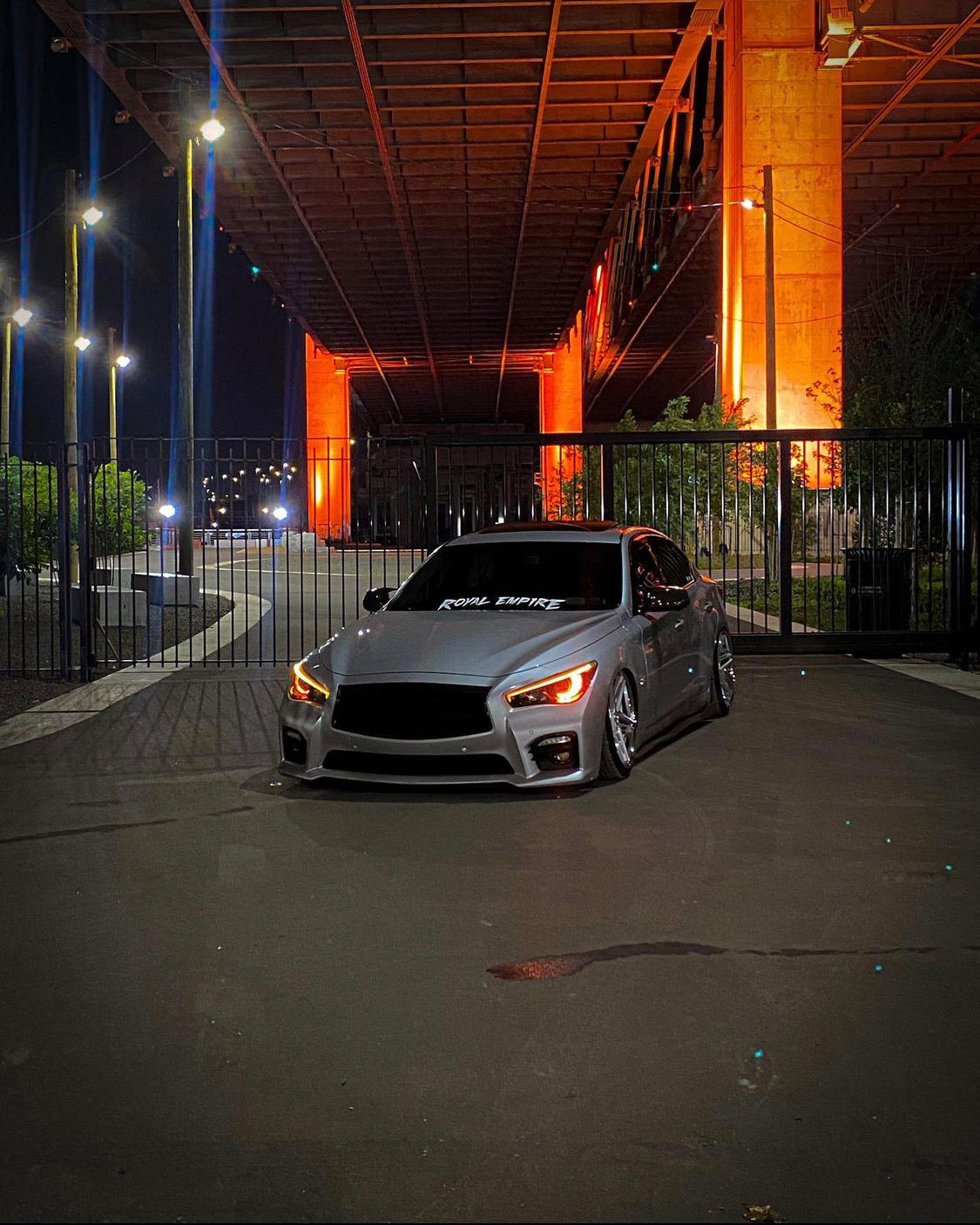 Infiniti Q50 RGBW Flow Series LED DRL boards on a silver sedan under lighting at night on Tampa Home & Garden Store
