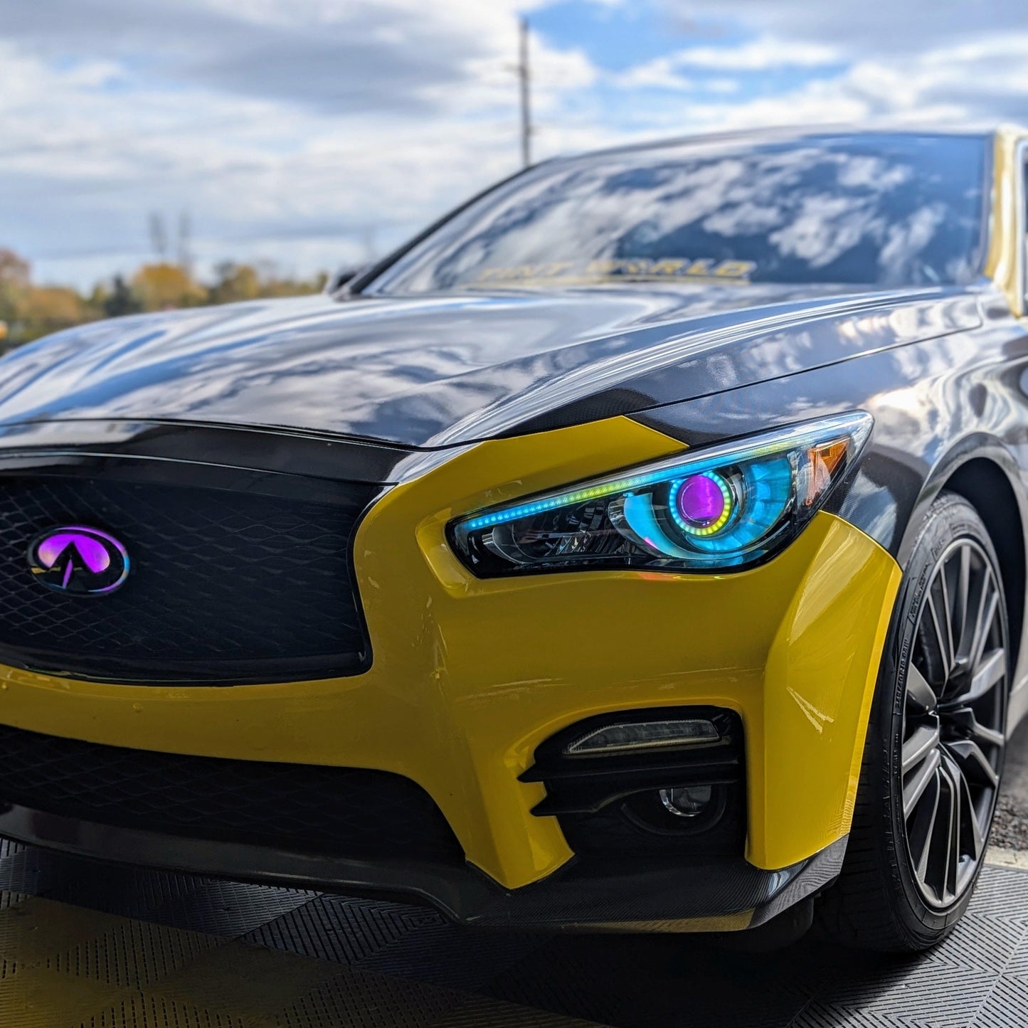 Infiniti Q50 RGBW Flow Series LED DRL boards on yellow sedan with Infiniti emblem on Tampa Home & Garden Store