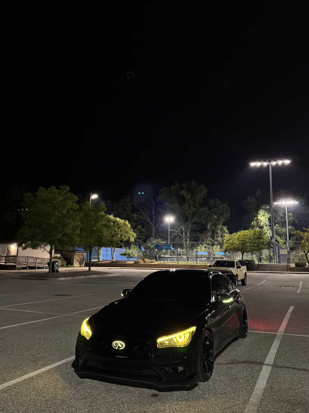 Infiniti Q50 RGBW Flow Series LED DRL boards by AutoLEDTech.com with yellow headlights at night on Tampa Home & Garden Store