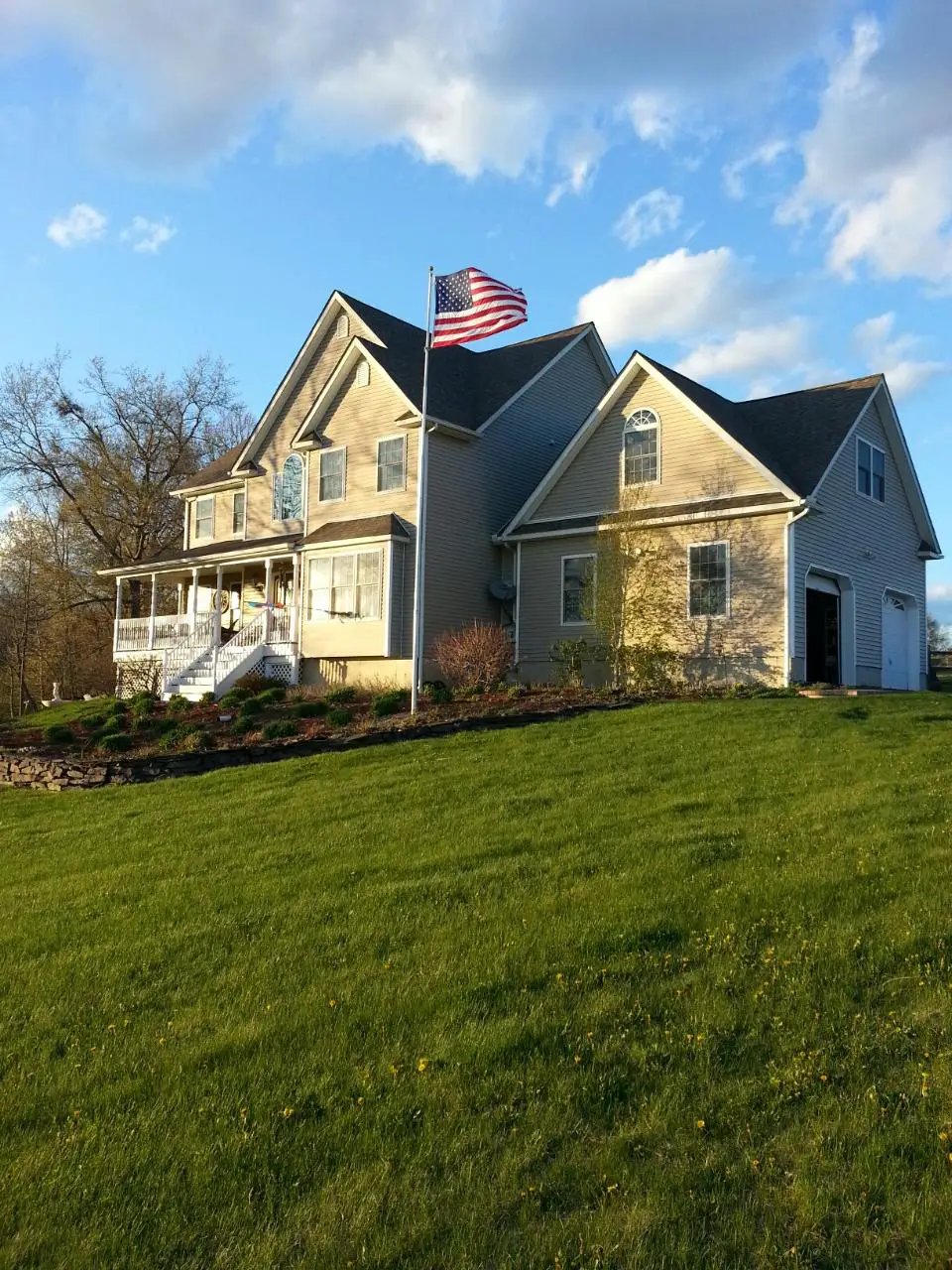 Titan telescoping flagpole by Flagman of America in yard with American flag Made in USA on Tampa Home & Garden Store