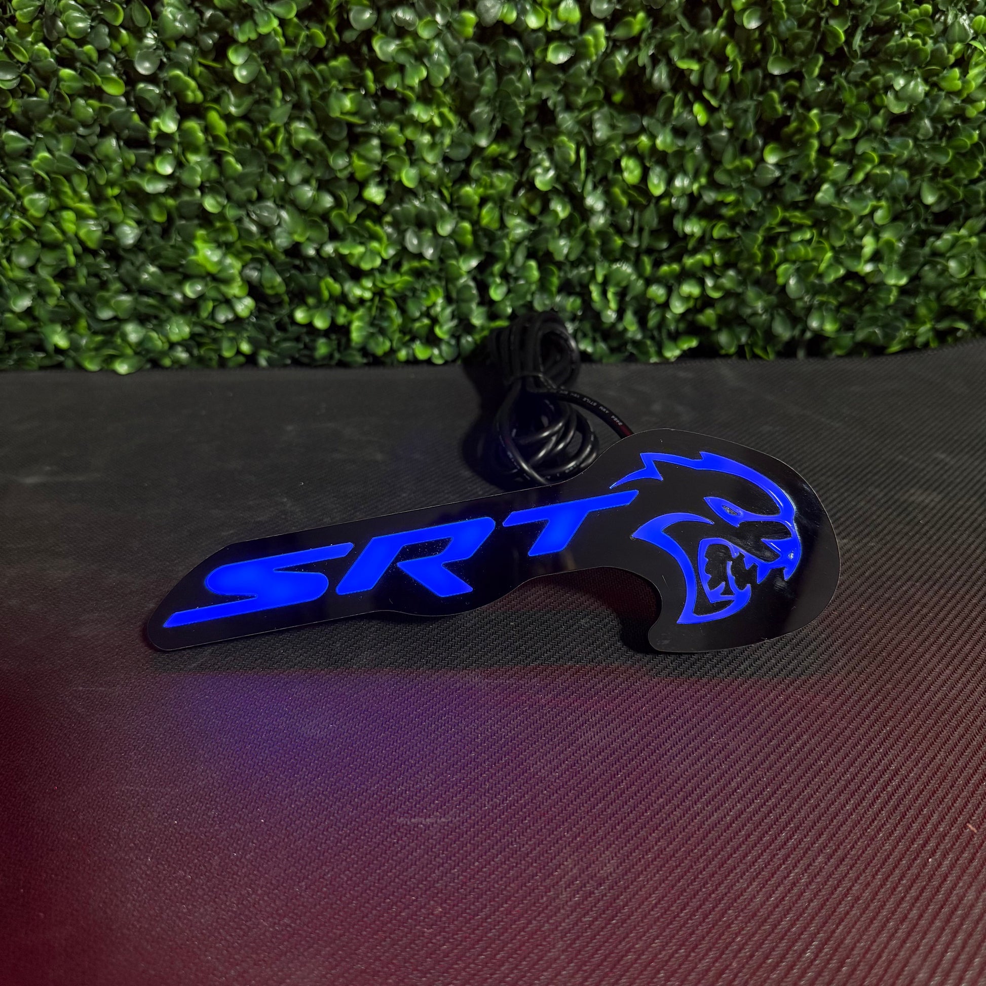 SRT Hellcat RGBW Flow Series LED badge emblem blue with wired harness visible on Tampa Home & Garden Store