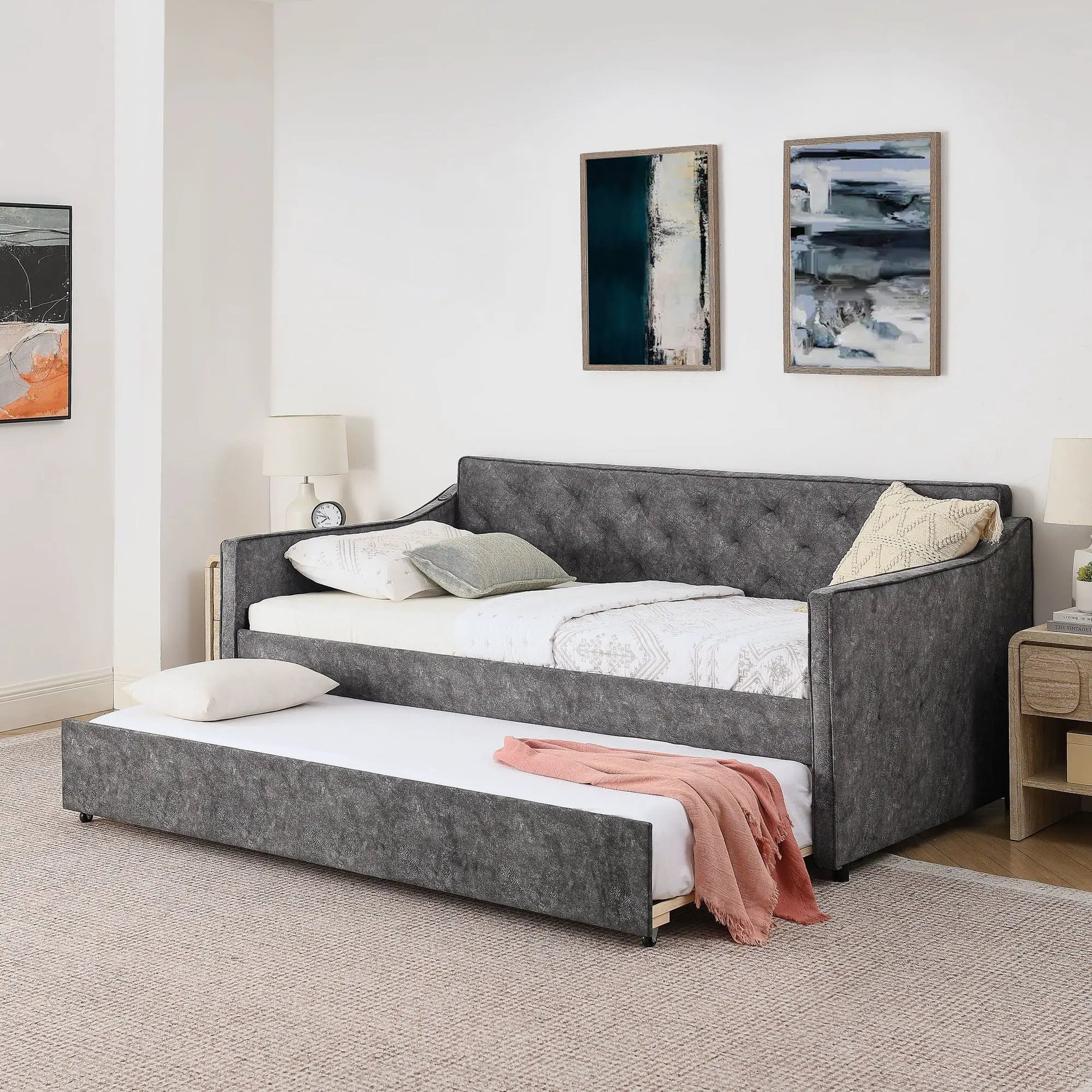 Daybed with pop-up trundle and USB charging armrest in dark grey fabric, white bedding on Tampa Home & Garden Store