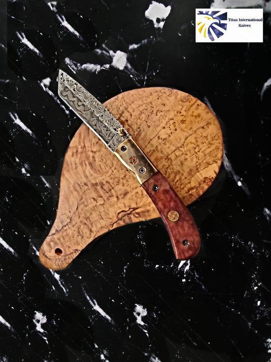 Damascus steel folding knife with tanto blade, dyed bone handle and copper bolster Titan logo on Tampa Home & Garden Store