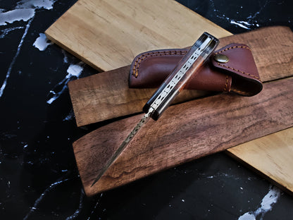 TF-009 knife by Titan International K with a patterned cutout blade and brown leather sheath on Tampa Home & Garden Store