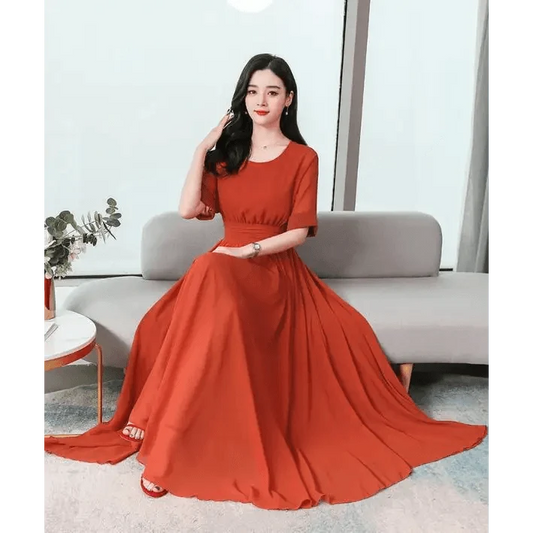 Fashion Luxury Long Chiffon Dress in red-orange, floor-length gown worn by a seated model on Tampa Home & Garden Store
