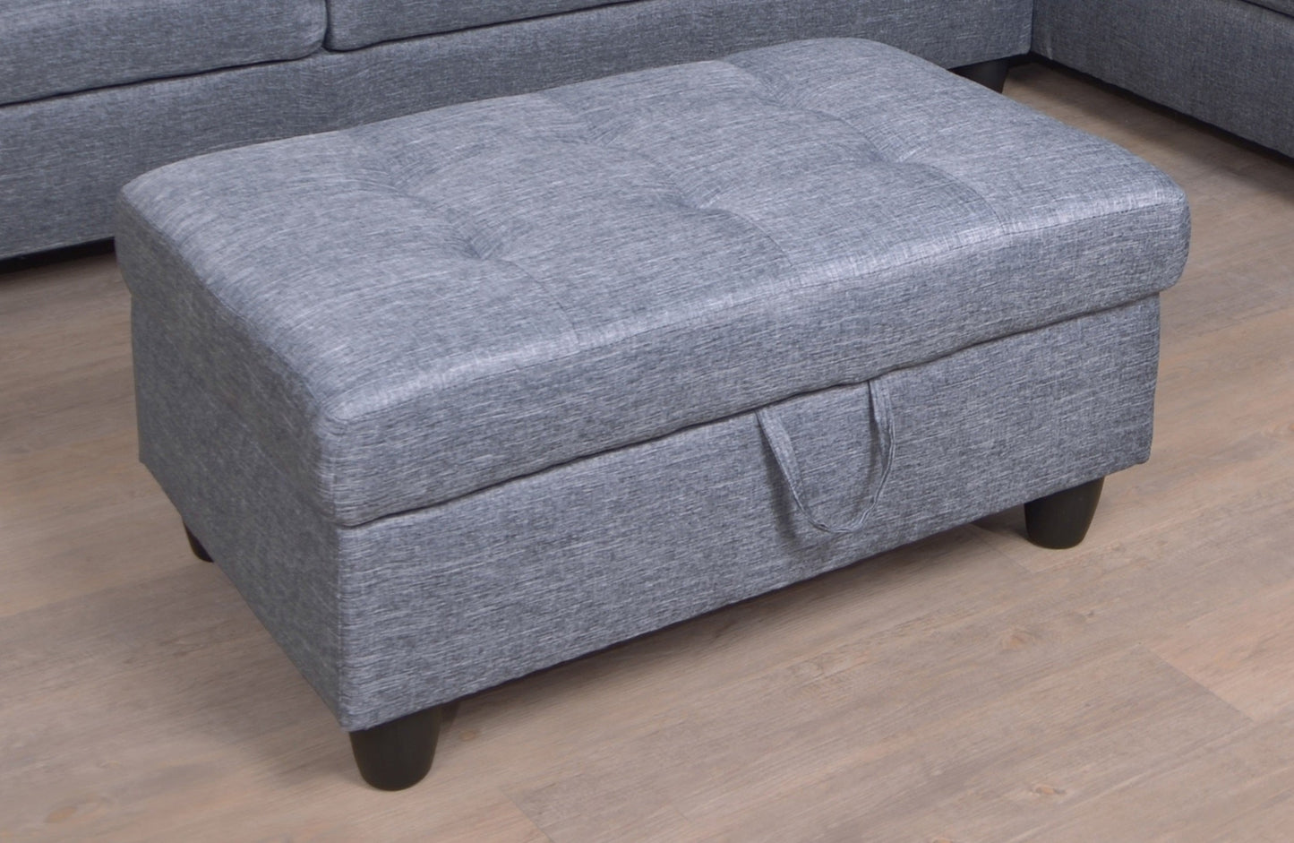Gray fabric sectional ottoman with tufted top and rounded edges on Tampa Home & Garden Store