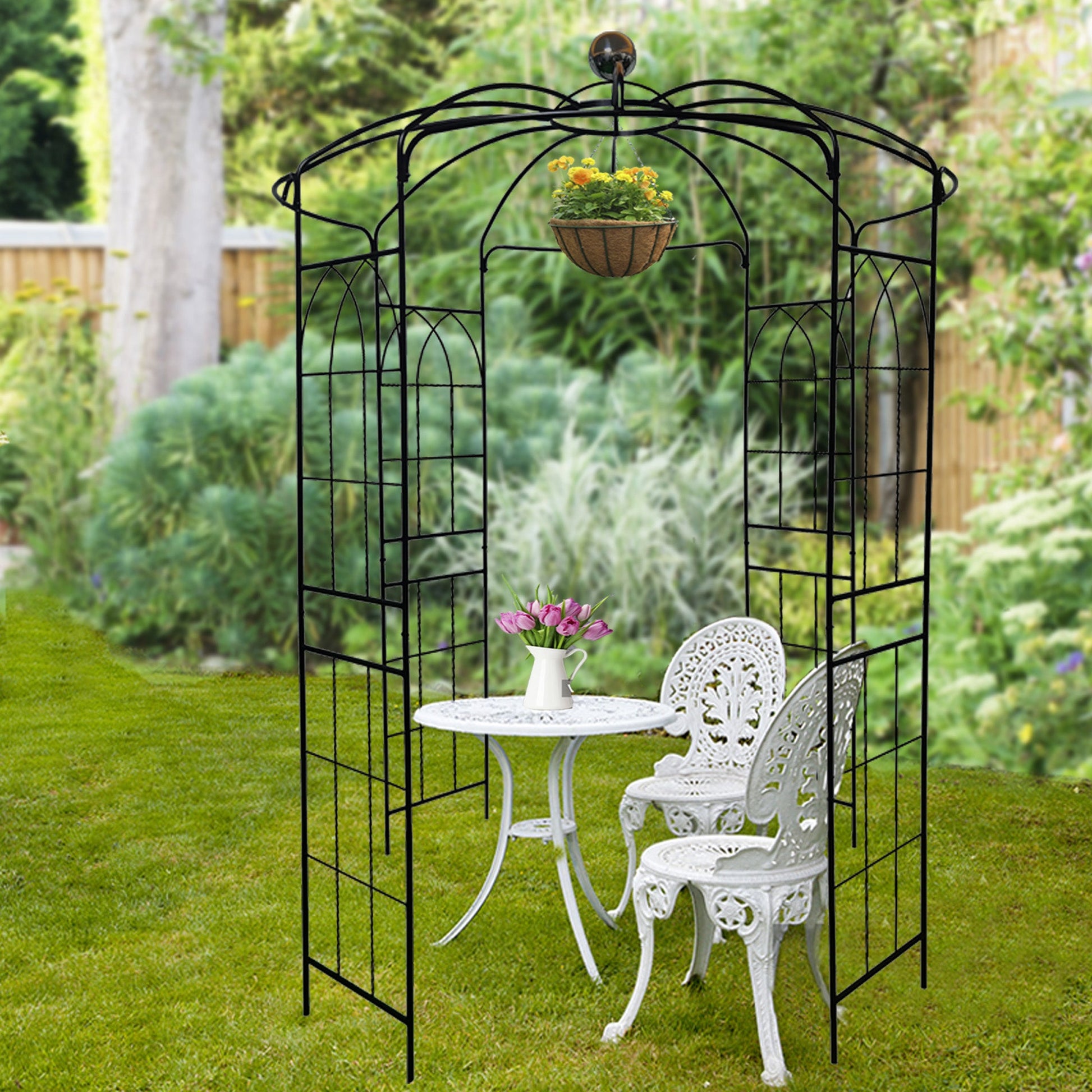 Black metal garden arch with hanging flower basket, iron trellis gazebo and patio furniture on Tampa Home & Garden Store