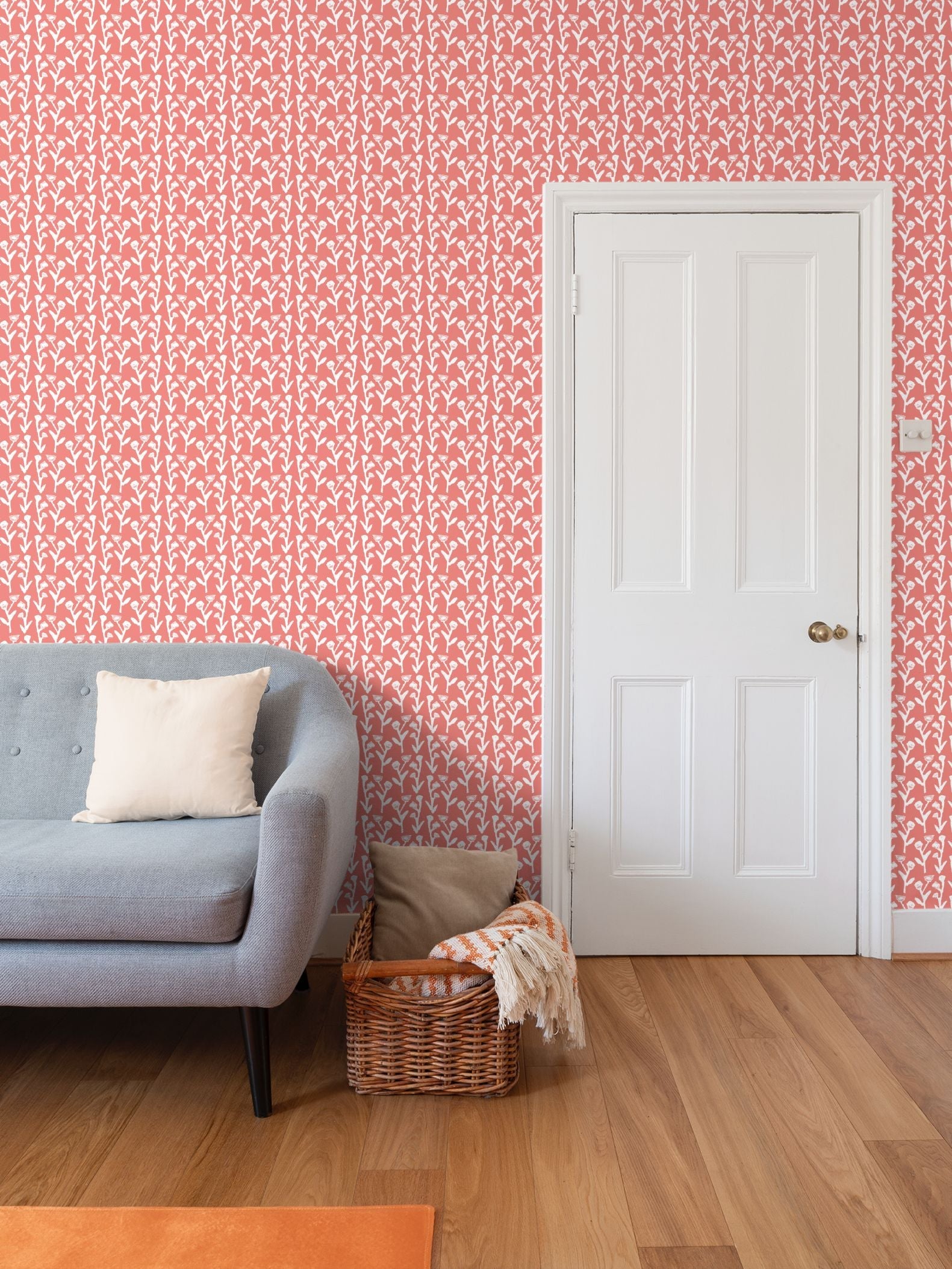 Ivy Manor Coral wallpaper by Erin Donahue Tice, repeat pattern on wall beside a white door on Tampa Home & Garden Store
