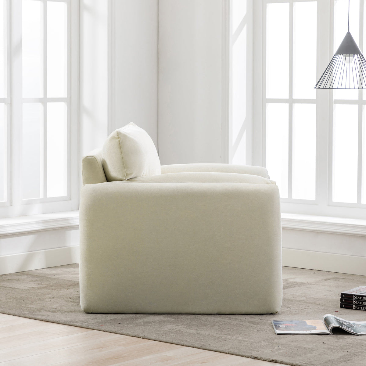 Modern Style Chenille Oversized Armchair cream upholstery near white paneled windows in a bright living space on Tampa Home & Garden Store