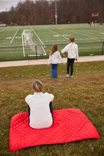 Iowa State University Red Puffer Blanket by Pretty Rugged, red quilted blanket on grass on Tampa Home & Garden Store