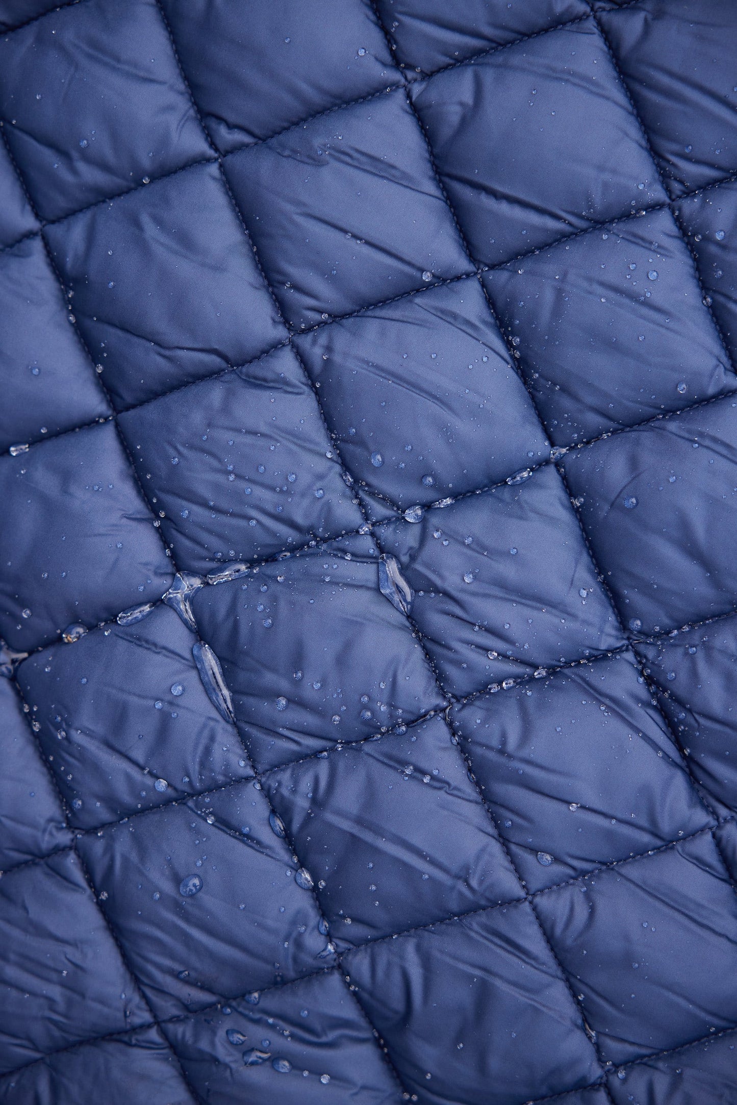Villanova Navy Puffer Blanket by Pretty Rugged, quilted grid with water droplets on Tampa Home & Garden Store