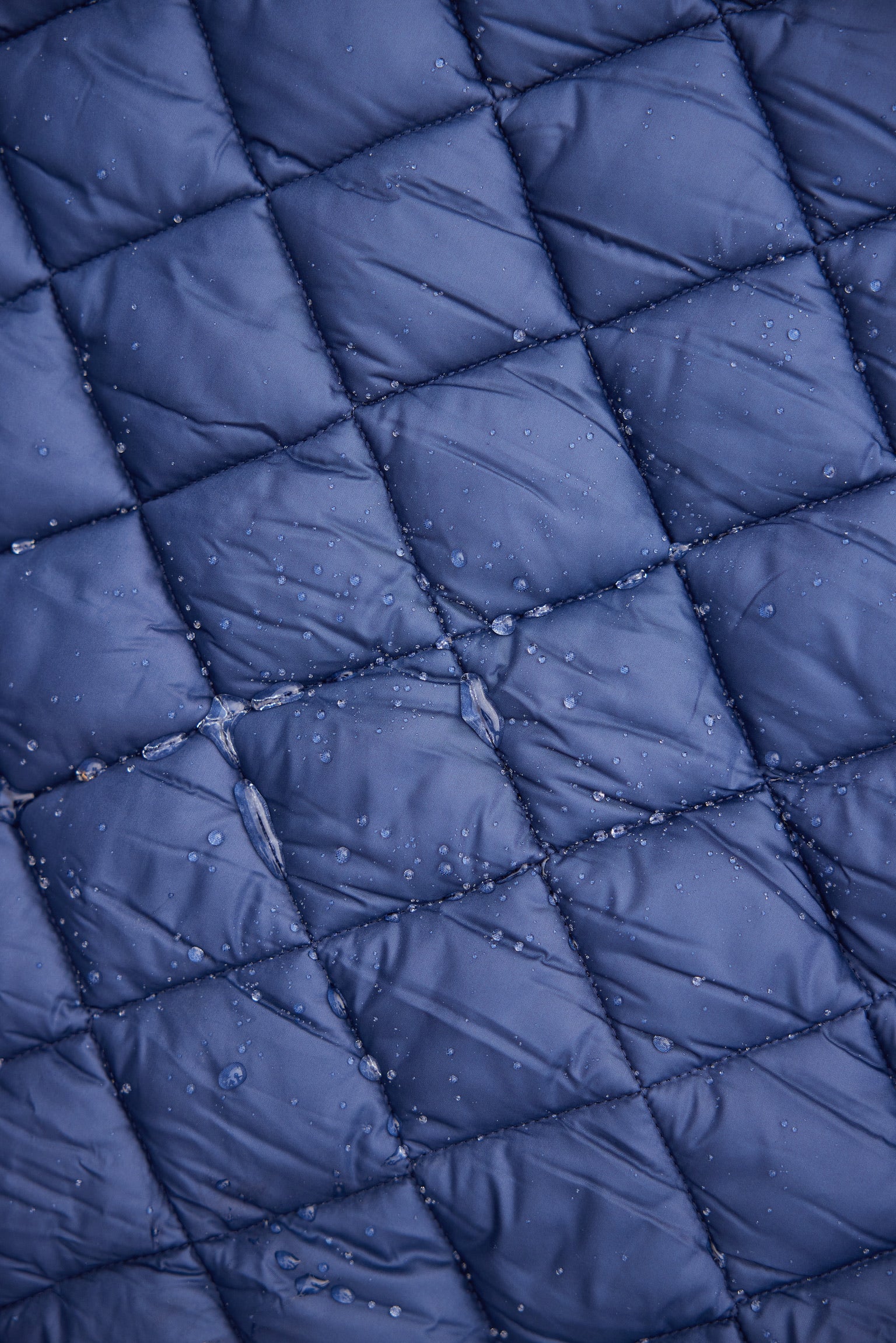Villanova Navy Puffer Blanket by Pretty Rugged, quilted grid with water droplets on Tampa Home & Garden Store