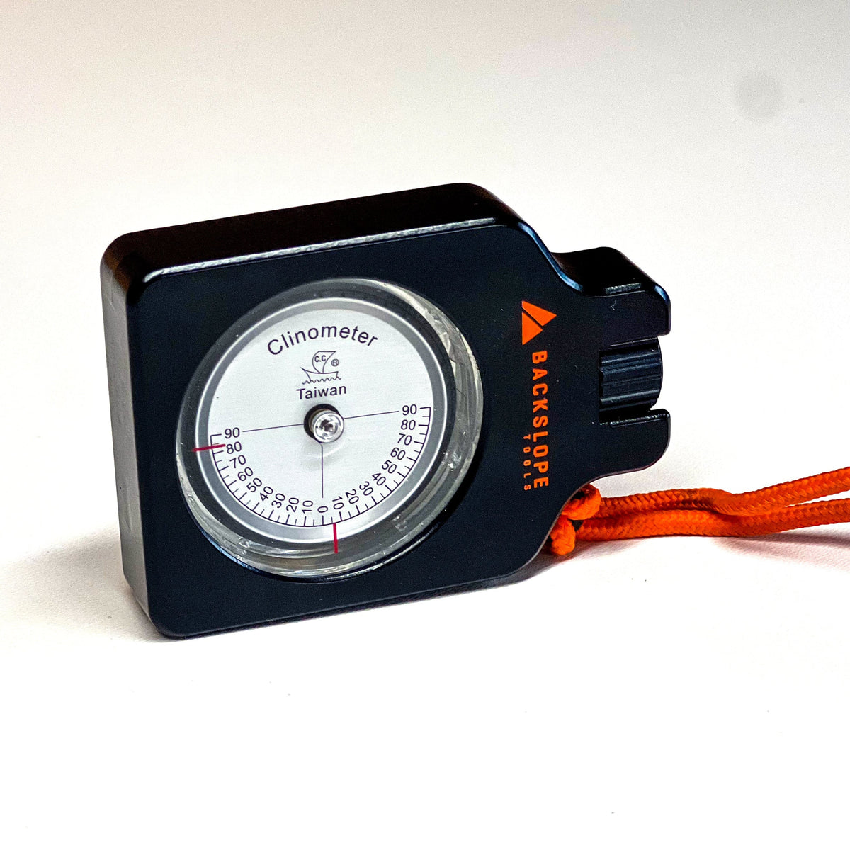 Klino clinometer by Backslope Tools, black housing with white dial and orange rope on Tampa Home & Garden Store