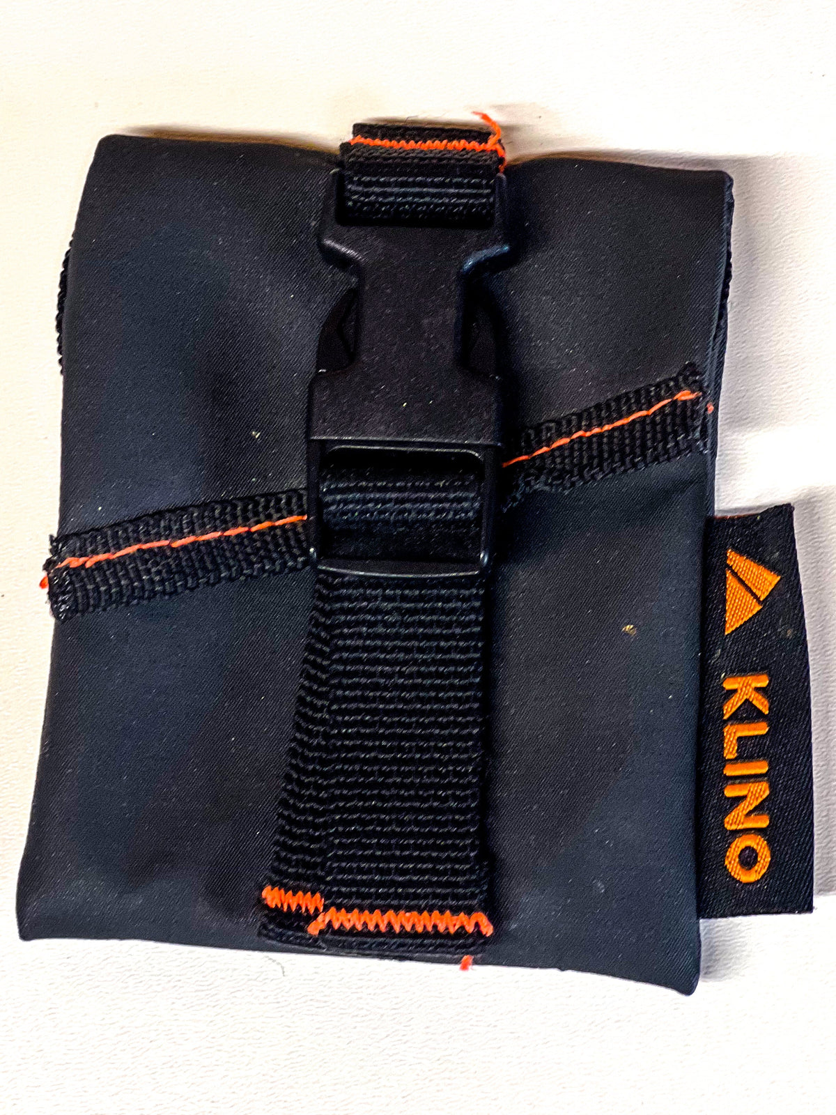Klino Kover tool pouch by Backslope Tools, black fabric with orange stitching and buckle on Tampa Home & Garden Store