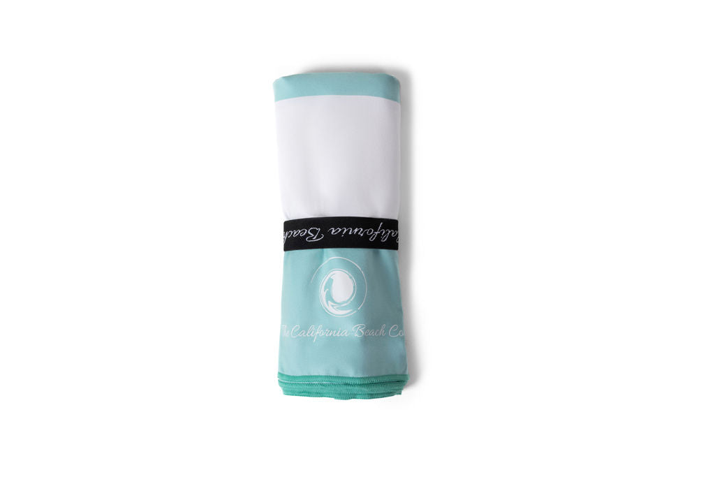 Coastline Beach Towel turquoise white with black branding band by The California Beach Company LLC on Tampa Home & Garden Store
