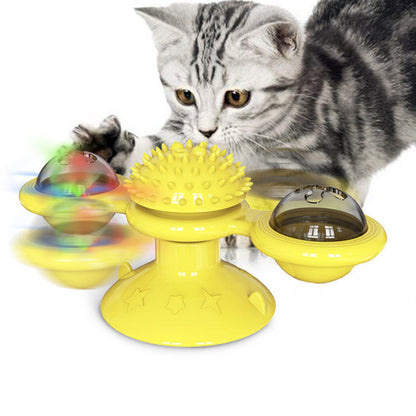 Yellow Sucker Turn Windmill Cat Toy with three balls and spiked center as cat plays on Tampa Home & Garden Store