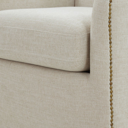 Swivel chair beige upholstery with brass bead trim along seam on Tampa Home & Garden Store