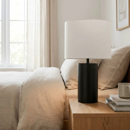 Aura table lamp with black base and white fabric shade on a wooden side table beside beige sofa on Tampa Home & Garden Store