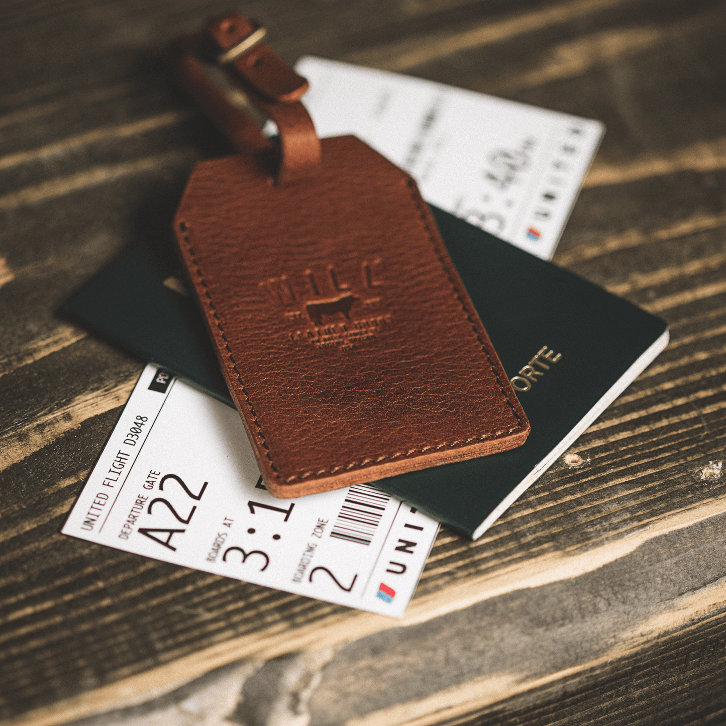 Brown leather luggage tag with stitched edges and attached strap by Will Leather Goods on Tampa Home & Garden Store
