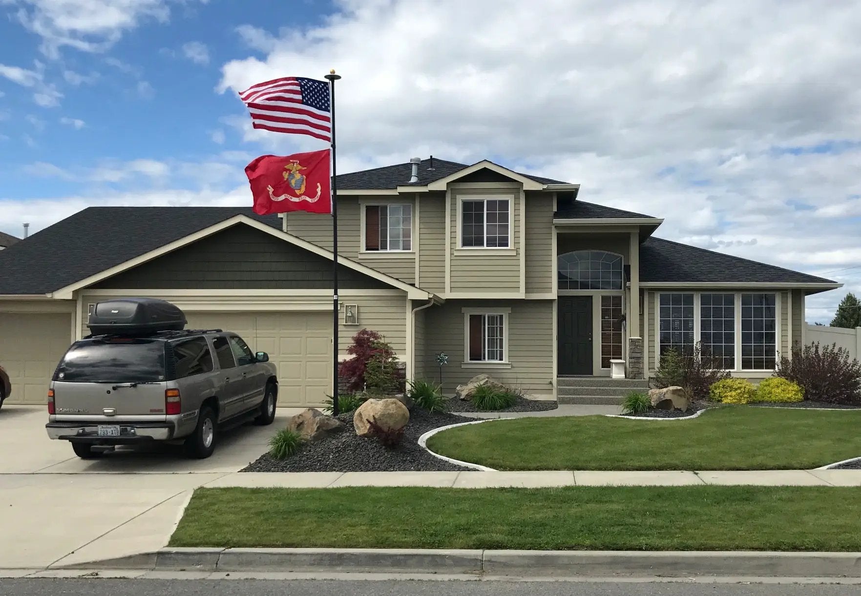 Titan Telescoping Flagpole, black metal, Flagman of America, with US and Marine flags on Tampa Home & Garden Store
