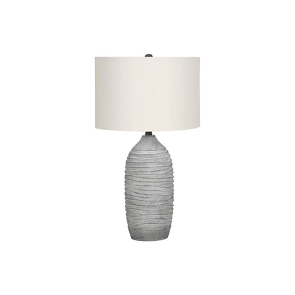 Table lamp with a gray textured resin base and cream fabric shade by Unique Piece Furniture on Tampa Home & Garden Store