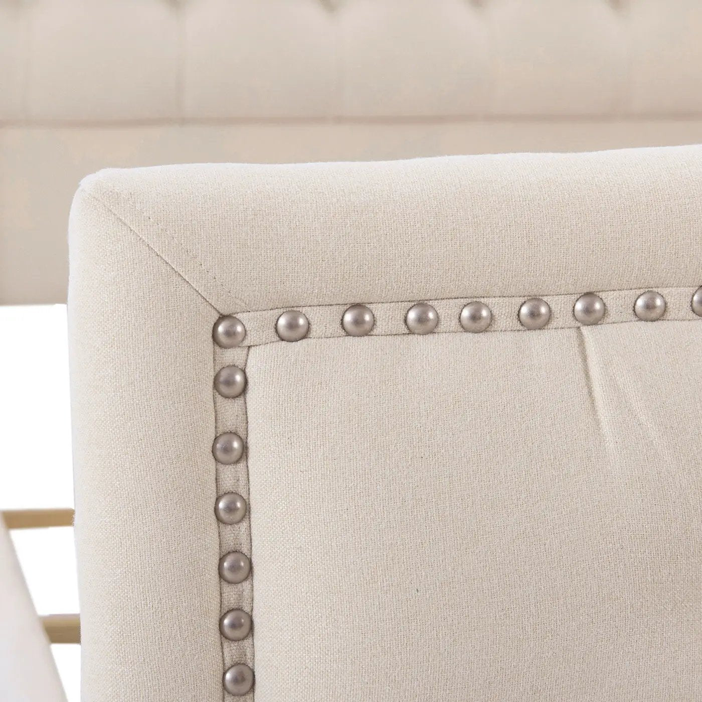 Marcella upholstered shelter headboard close-up in beige fabric with silver nailhead trim on Tampa Home & Garden Store