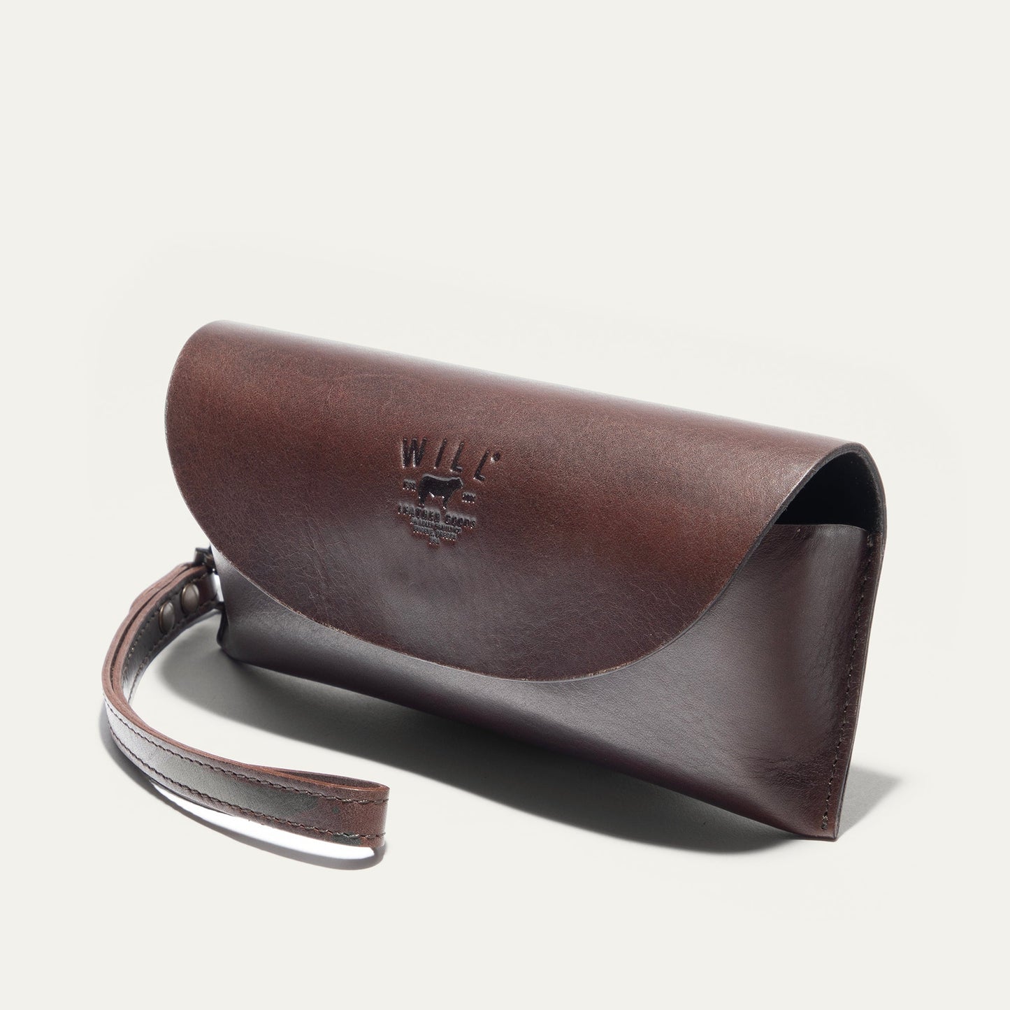 Brown leather roll-top eyeglass case by Will Leather Goods with embossed logo on Tampa Home & Garden Store