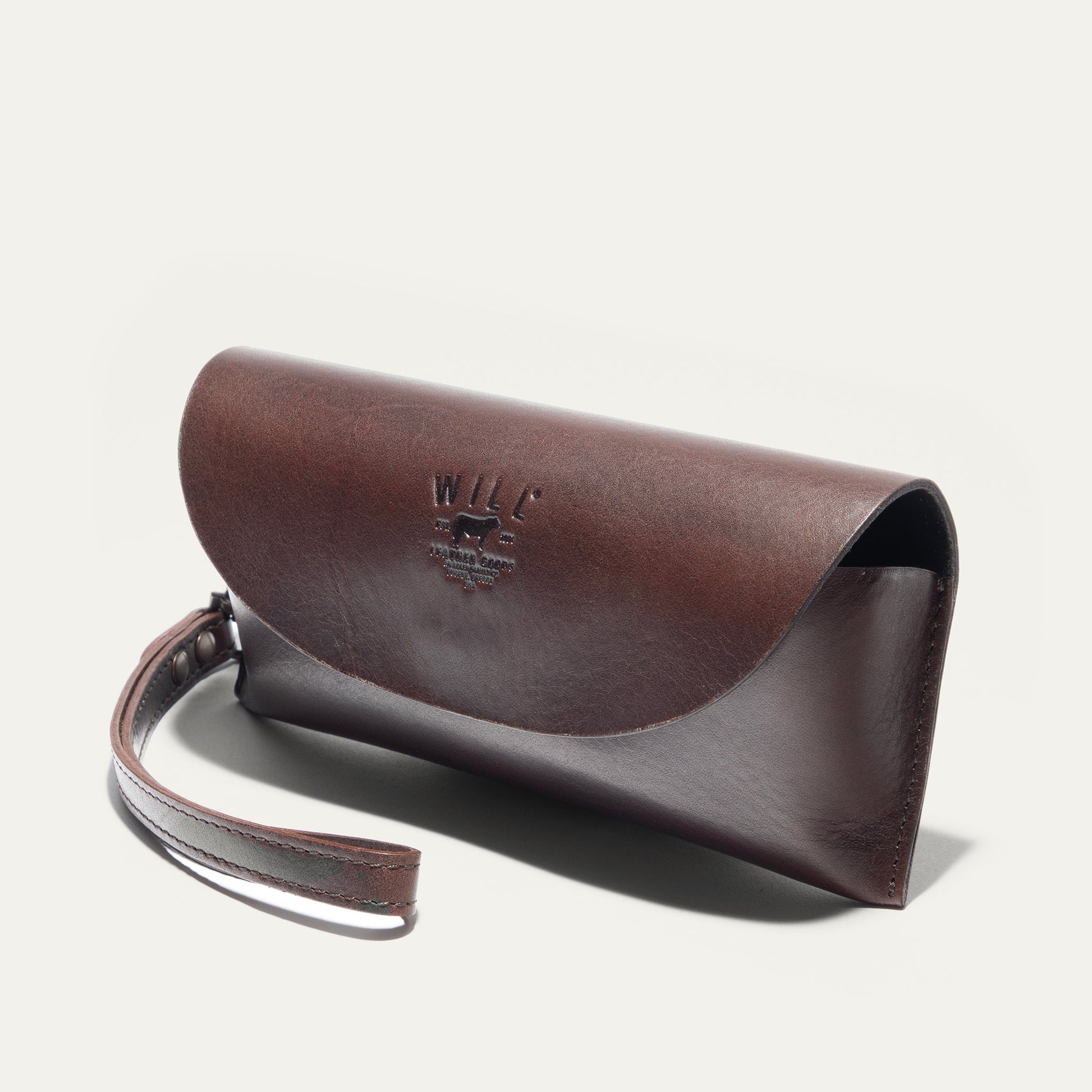 Brown leather roll-top eyeglass case by Will Leather Goods with embossed logo on Tampa Home & Garden Store