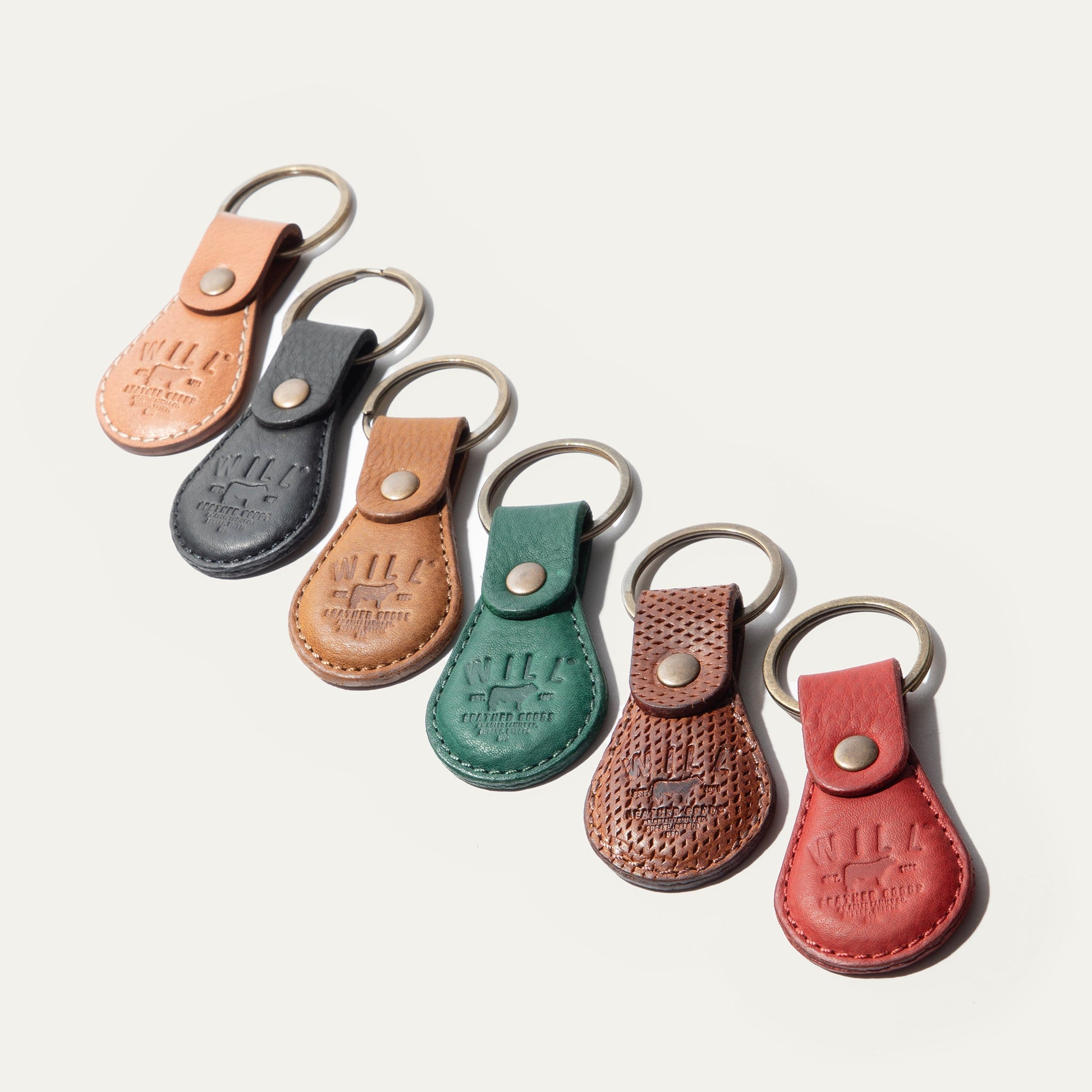 Logo Keychain set by Will Leather Goods in assorted leather colors (peach, gray, green, brown, red) on Tampa Home & Garden Store