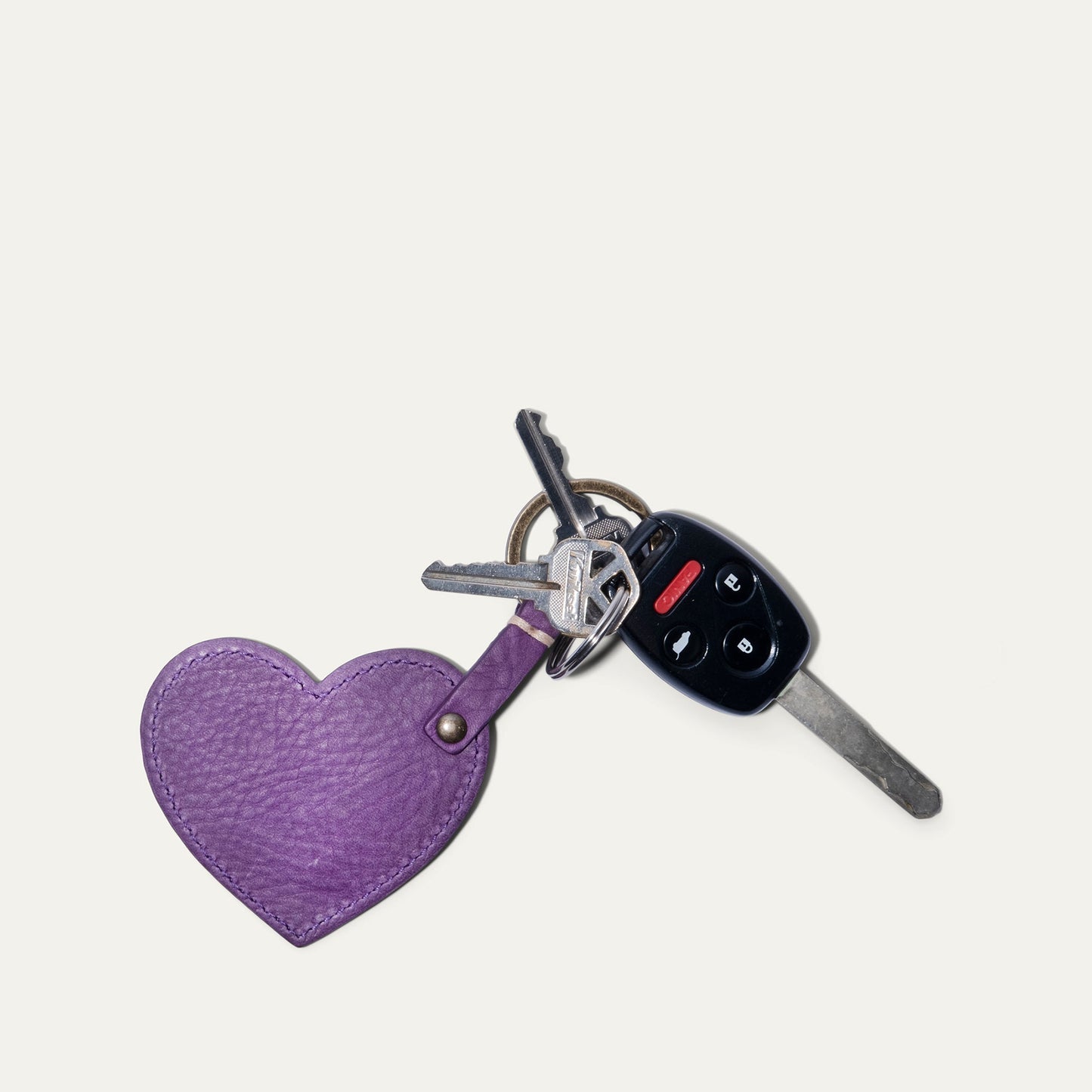 Heart keychain in purple leather attached to a car remote and metal keys on Tampa Home & Garden Store