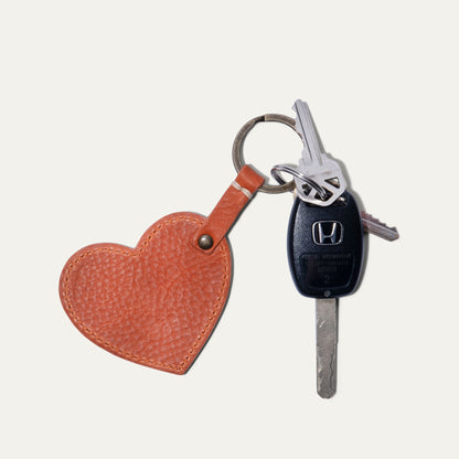 Heart keychain with orange leather fob and brass ring beside car keys Will Leather Goods on Tampa Home & Garden Store