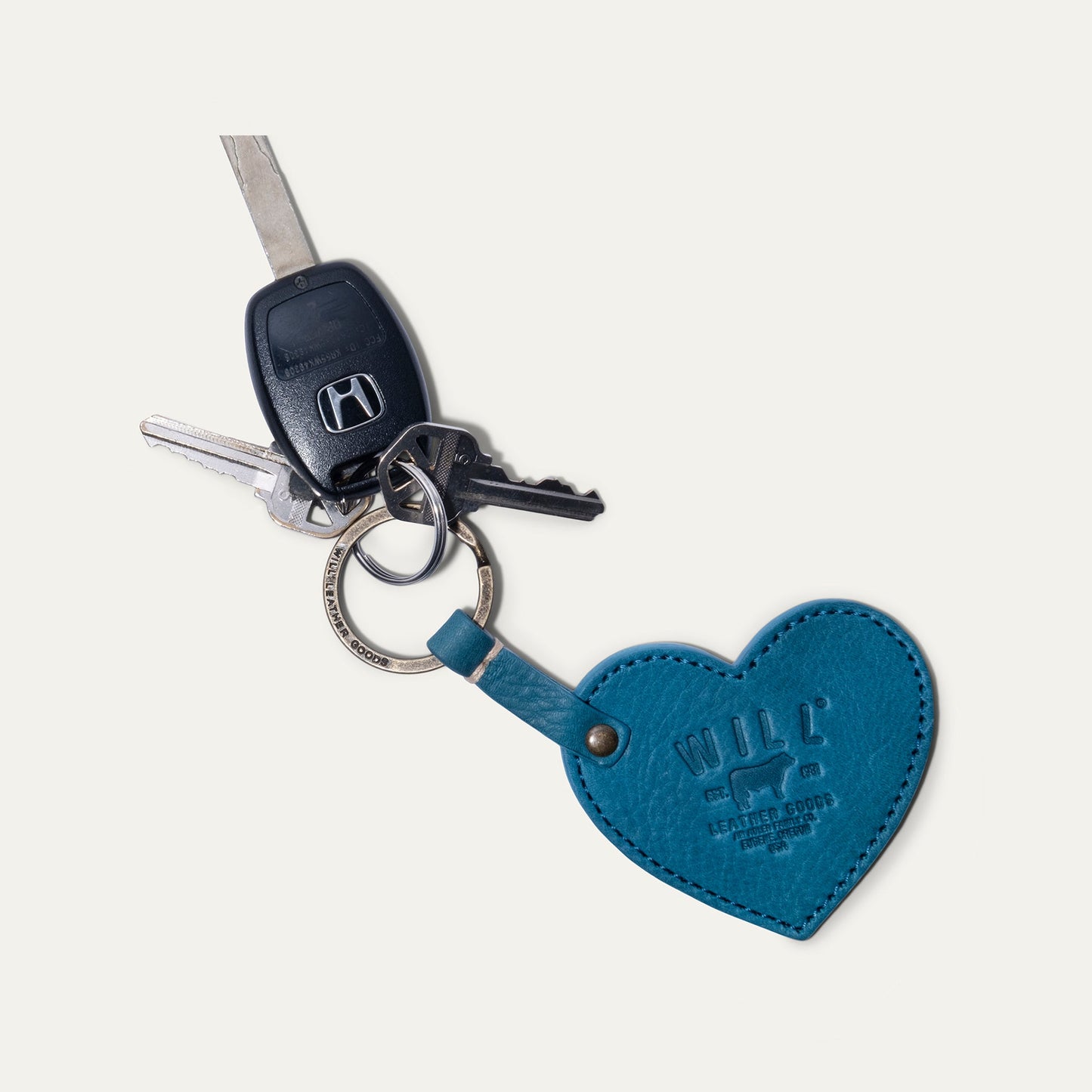 Heart keychain blue leather with Will Leather Goods branding on a metal keyring with several keys on Tampa Home & Garden Store