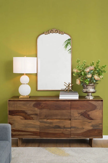 Arch Mirror with baroque gold ornate frame on olive wall above dresser with lamp and flowers on Tampa Home & Garden Store