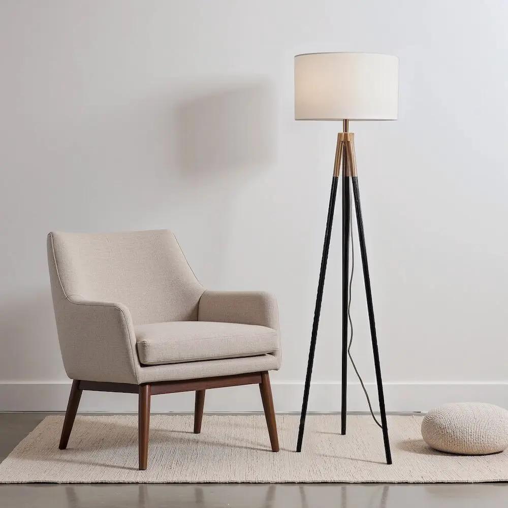 Sway floor lamp with triple black legs, gold accents, and white fabric shade on Tampa Home & Garden Store