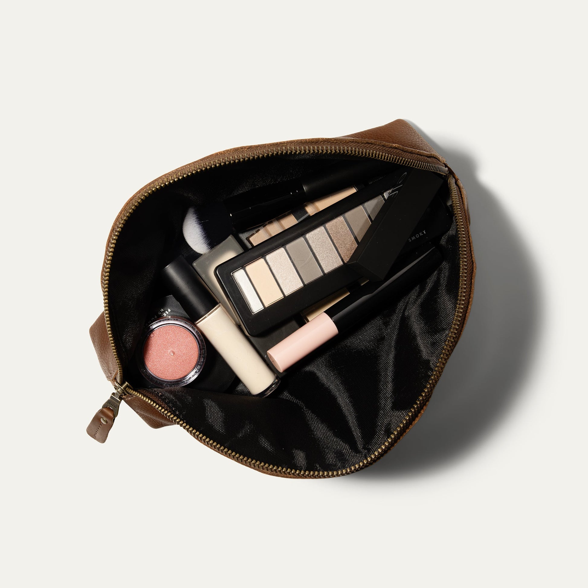 Zip Cosmetic makeup bag in brown leather opened to reveal palette, brushes and tubes on Tampa Home & Garden Store