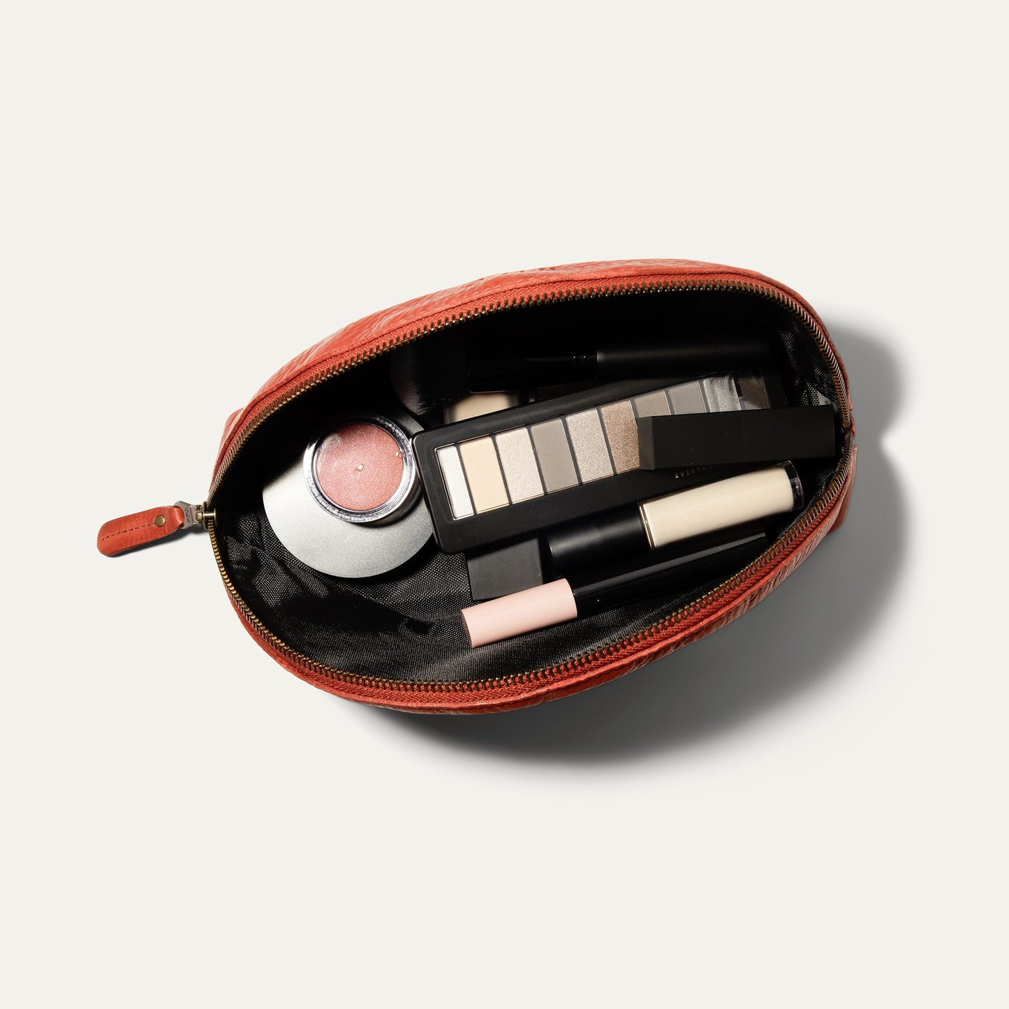 Zip Cosmetic bag by Will Leather Goods in coral leather, open to makeup palette and lipstick on Tampa Home & Garden Store